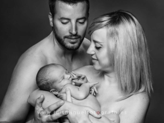 Foto newborn de bebe recien nacido en brazos de su mama  y papa
